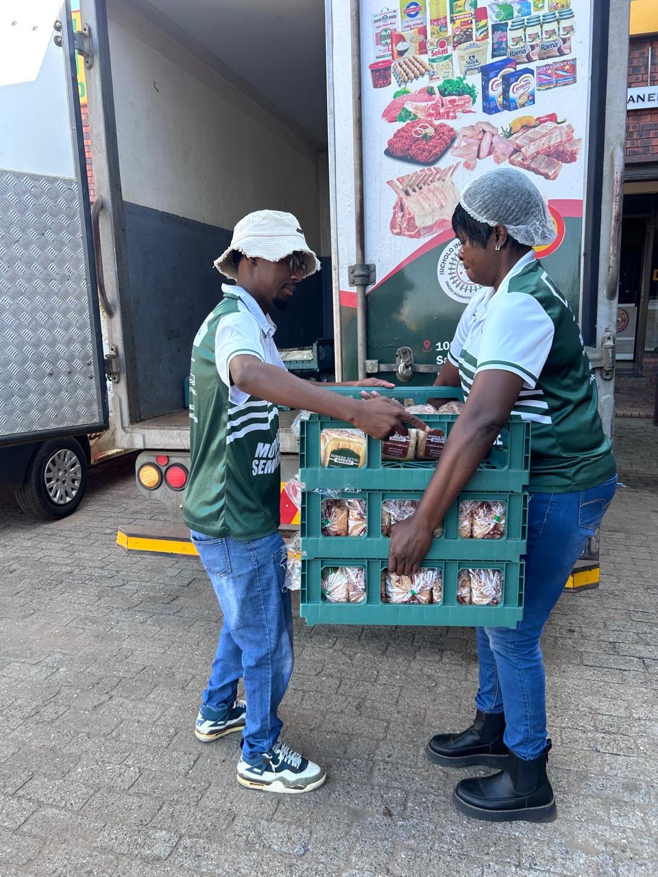 Isinkwa Sethu team loading bread crates into the delivery truck