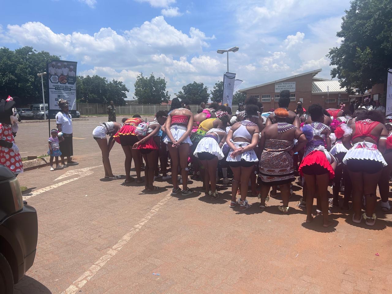 Community gathering at an open venue supported by Isicholo
